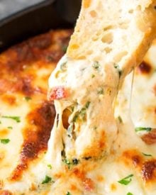 Cheesy Bacon Spinach Dip | This party spinach dip is loaded with tons of spinach, gooey cheese, crispy bacon and other mouthwatering flavors. Combine, bake, and eat! Perfect for a party! | http://thechunkychef.com