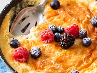 Mixed Berry Baked Oatmeal Souffle | Soft, fluffy oatmeal is folded with whipped egg whites and swirled with mixed berries, then baked until puffed and golden! | http://thechunkychef.com