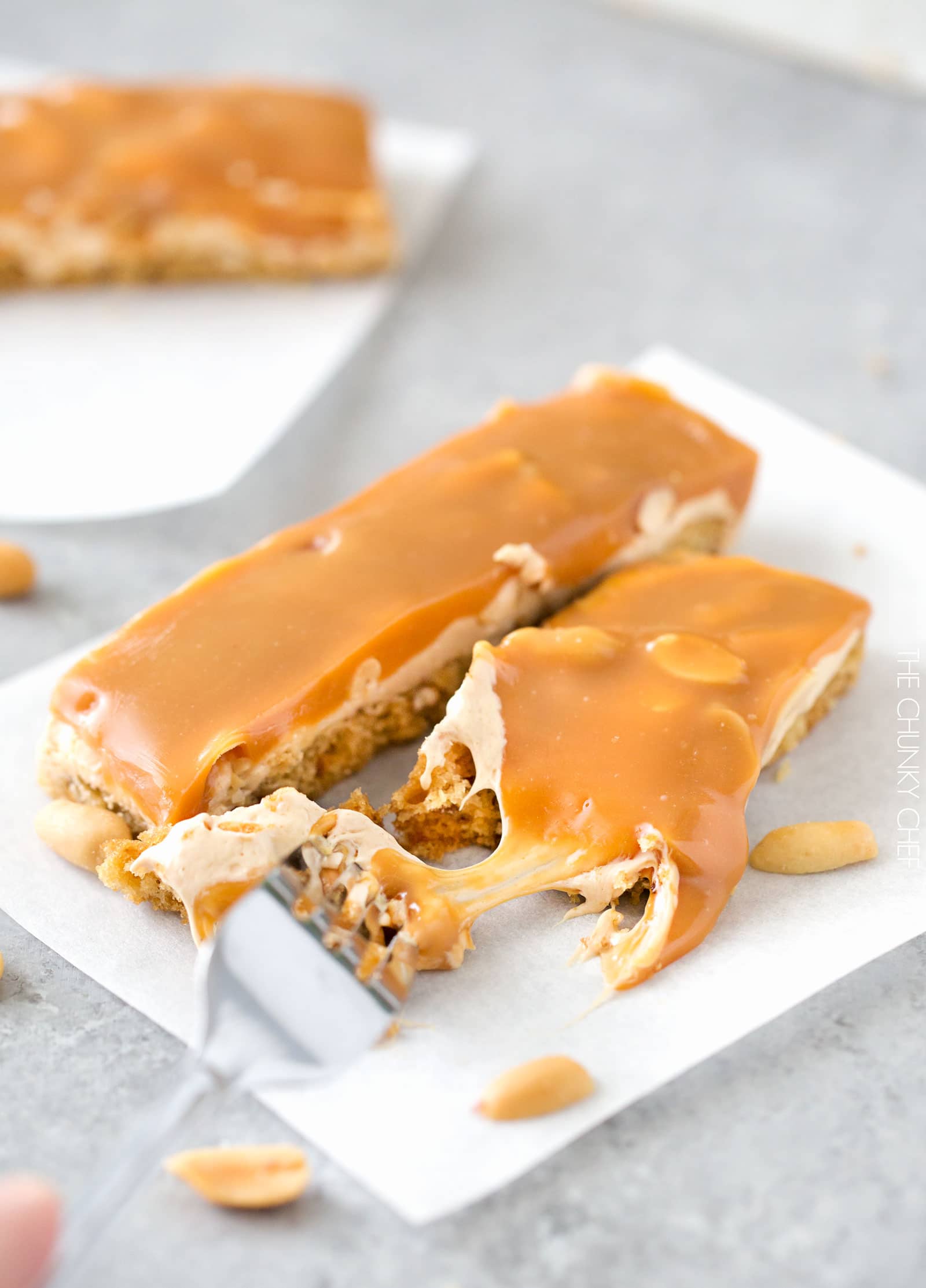 Salted Caramel Peanut Bars | These easy to make bars taste like a great candy bar! A soft pretzel flavored base is covered with a creamy nougat layer, sprinkled with peanuts, and coated in dreamy salted caramel! | http://thechunkychef.com