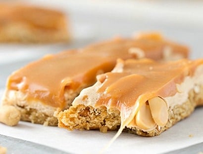 Salted Caramel Peanut Bars | These easy to make bars taste like a great candy bar! A soft pretzel flavored base is covered with a creamy nougat layer, sprinkled with peanuts, and coated in dreamy salted caramel! | http://thechunkychef.com
