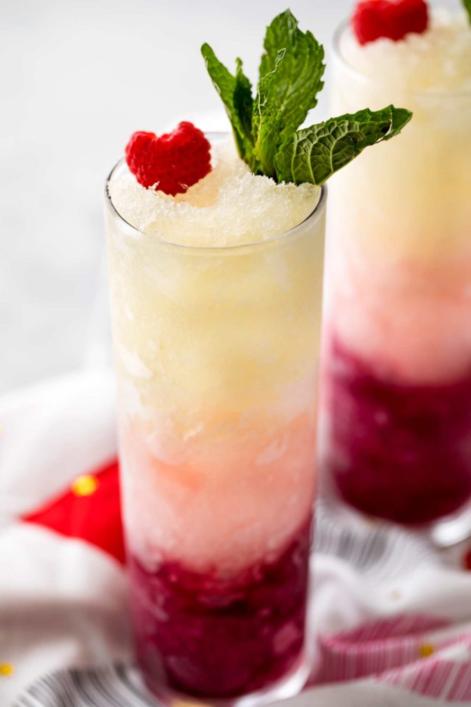 Three types of sweet wine are frozen, blended with simple syrup, and layered to create a drink that's every bit as delicious as it is beautiful! #slush #slushy #slushie #wine #ombre #valentinesday #frozendrink #mothersday #cocktail #icy