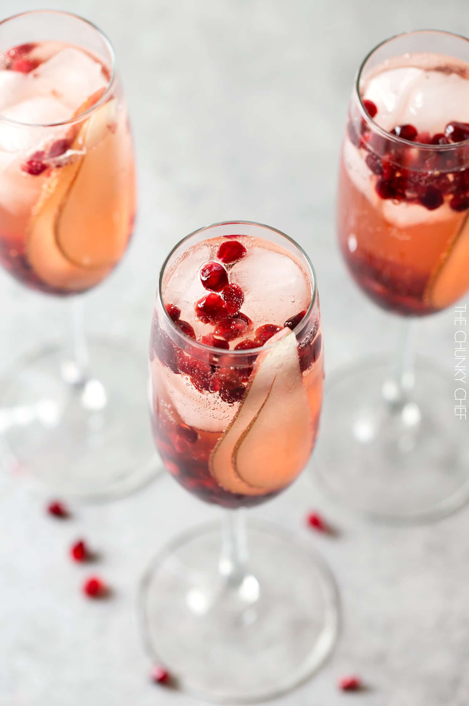 Pear Pomegranate Bellini | A delightful combination of Prosecco and pear brandy create this light, bubbly, and elegant Bellini! As pretty as it is delicious, it's just the drink you need for your next party or date night! | http://thechunkychef.com