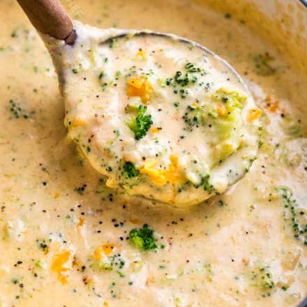 Ladle of broccoli cheddar soup in soup pot