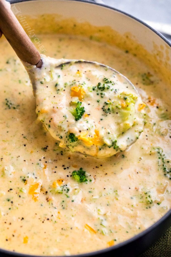 Ladle of broccoli cheddar soup in soup pot