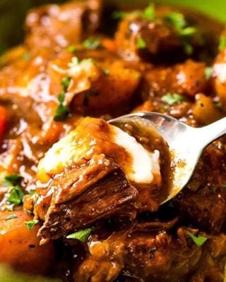 This comfort food is the King of all Irish beef stews, with the Guinness and coffee flavors melding perfectly to give way to a deep, rich, lusciously savory sauce that simmers away to tenderize the beef and vegetables until they're spoonable! #beefstew #irish #stpatricksday #stew #beef #guinness #coffee #slowcooker #crockpot #instantpot #pressurecooker