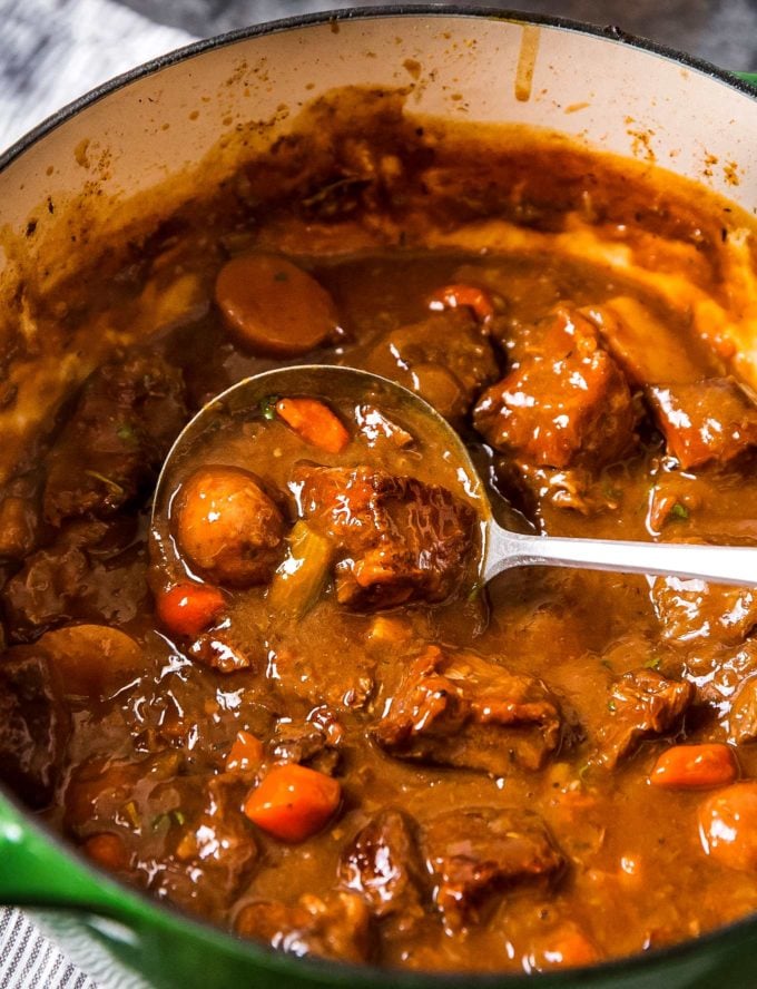 Irish beef stew in dutch oven with ladle