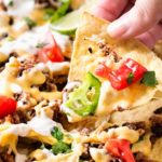 Sheet Pan Beef and Black Bean Nachos | These sheet pan nachos are sure to be a crowd pleaser! Layer after layer of mouthwatering flavor, smothered with a jalapeño cheese sauce and loaded with classic nacho toppings! | http://thechunkychef.com