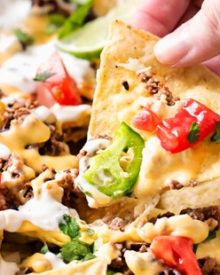 Sheet Pan Beef and Black Bean Nachos | These sheet pan nachos are sure to be a crowd pleaser! Layer after layer of mouthwatering flavor, smothered with a jalapeño cheese sauce and loaded with classic nacho toppings! | http://thechunkychef.com