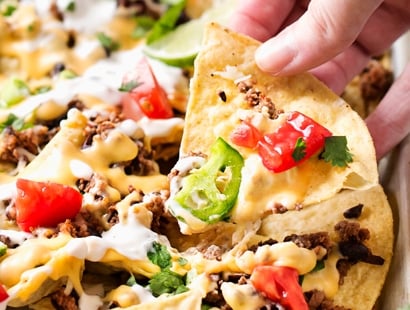 Sheet Pan Beef and Black Bean Nachos | These sheet pan nachos are sure to be a crowd pleaser! Layer after layer of mouthwatering flavor, smothered with a jalapeño cheese sauce and loaded with classic nacho toppings! | http://thechunkychef.com