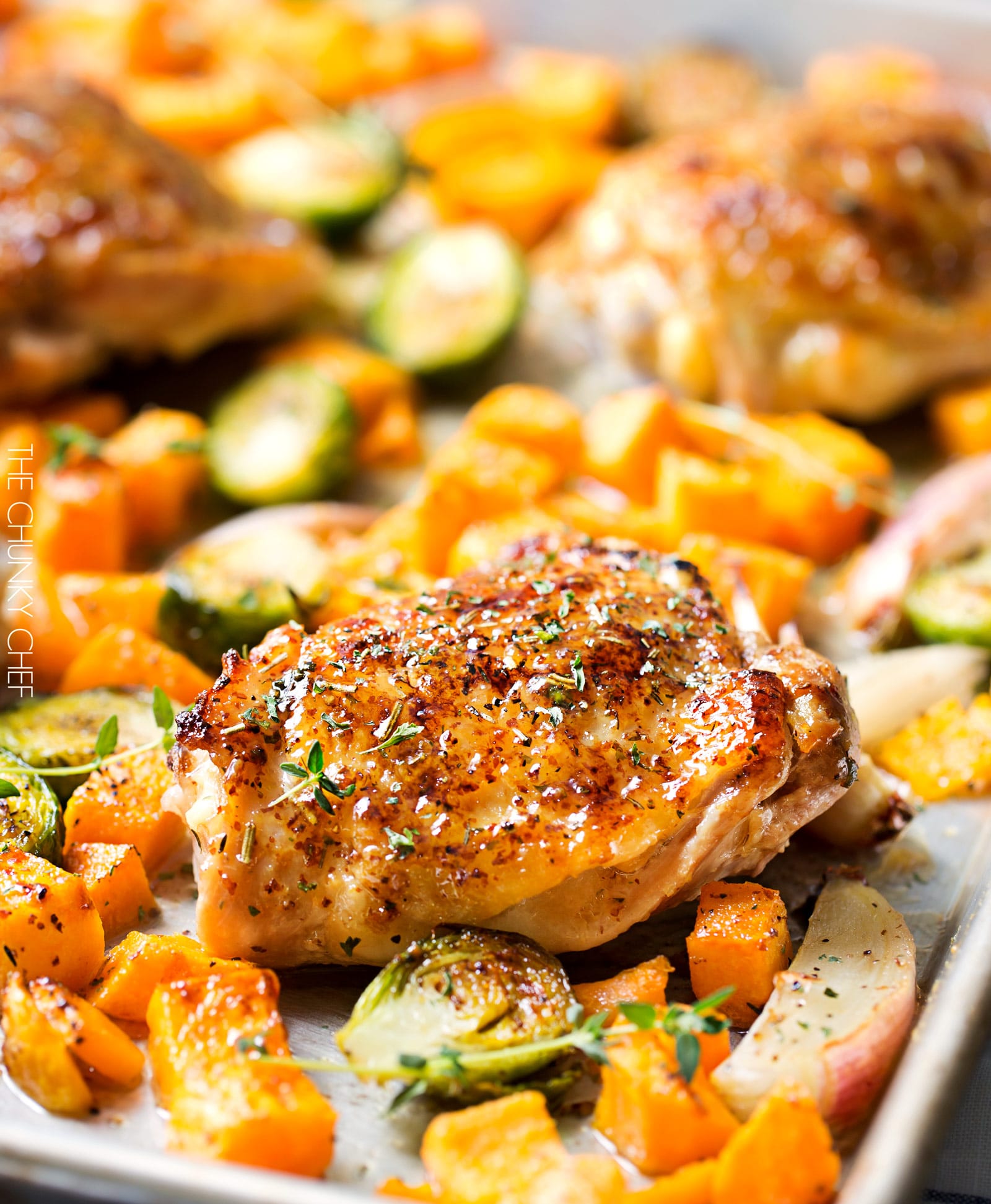 Sheet Pan Maple Mustard Roasted Chicken | Chicken thighs are coated in a sweet and savory maple mustard sauce and roasted alongside creamy butternut squash and savory brussels sprouts, all on one sheet pan for an incredibly quick, easy meal with hardly any cleanup needed! | http://thechunkychef.com