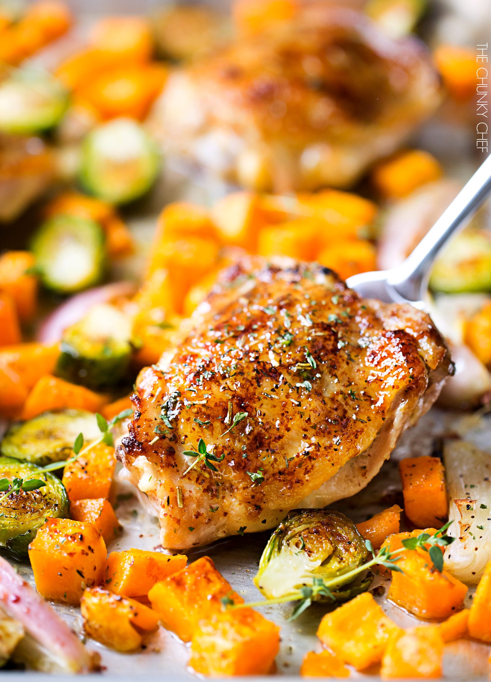 Sheet Pan Maple Mustard Roasted Chicken | Chicken thighs are coated in a sweet and savory maple mustard sauce and roasted alongside creamy butternut squash and savory brussels sprouts, all on one sheet pan for an incredibly quick, easy meal with hardly any cleanup needed! | http://thechunkychef.com