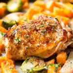 Sheet Pan Maple Mustard Roasted Chicken | Chicken thighs are coated in a sweet and savory maple mustard sauce and roasted alongside creamy butternut squash and savory brussels sprouts, all on one sheet pan for an incredibly quick, easy meal with hardly any cleanup needed! | http://thechunkychef.com