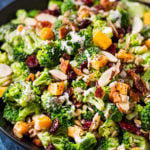The ultimate broccoli salad is made with crunchy almonds, bacon, sunflower seeds, tart cranberries, and a creamy citrus poppyseed dressing!  Perfect make-ahead holiday side dish recipe! #sidedish #broccoli #salad #easter #memorialday #summer #easyrecipe #makeahead