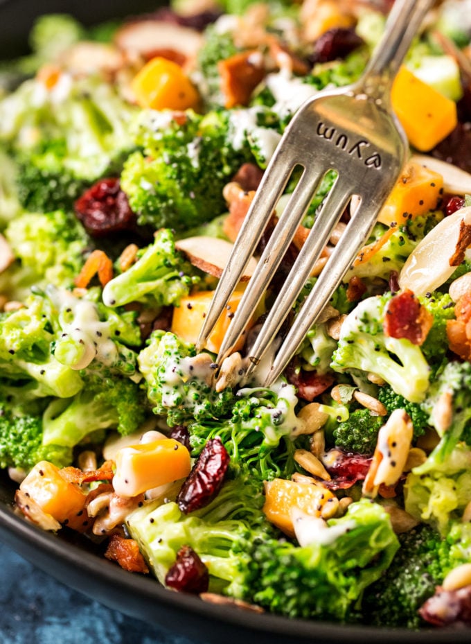 The ultimate broccoli salad is made with crunchy almonds, bacon, sunflower seeds, tart cranberries, and a creamy citrus poppyseed dressing!  Perfect make-ahead holiday side dish recipe! #sidedish #broccoli #salad #easter #memorialday #summer #easyrecipe #makeahead