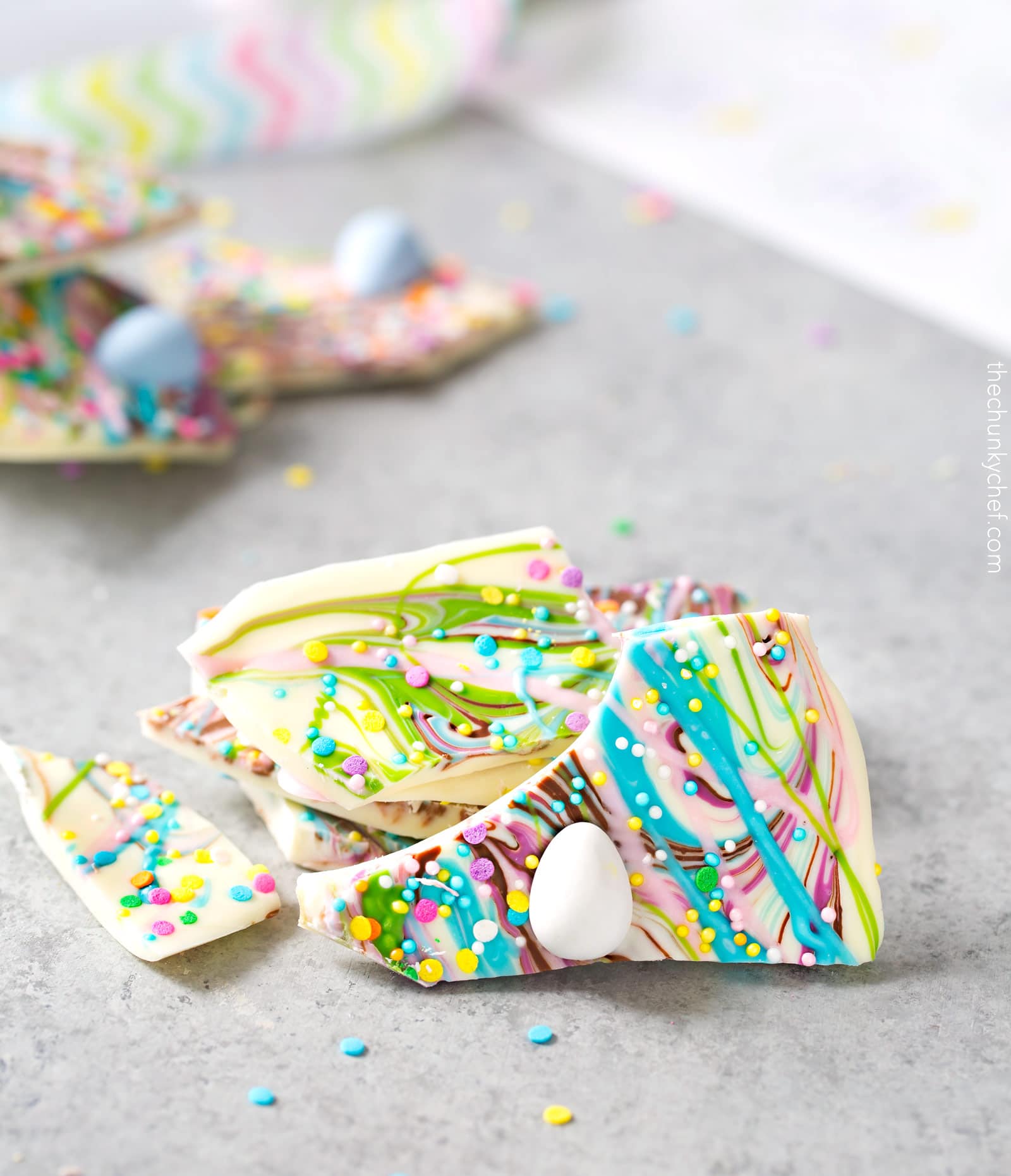 Brownie Batter White Chocolate Bark | A fun no bake bark dessert, made with white chocolate swirled together with milk chocolate brownie batter, and decorated in fun Spring colors! Easily customizable to any holiday and makes a great homemade gift! | http://thechunkychef.com