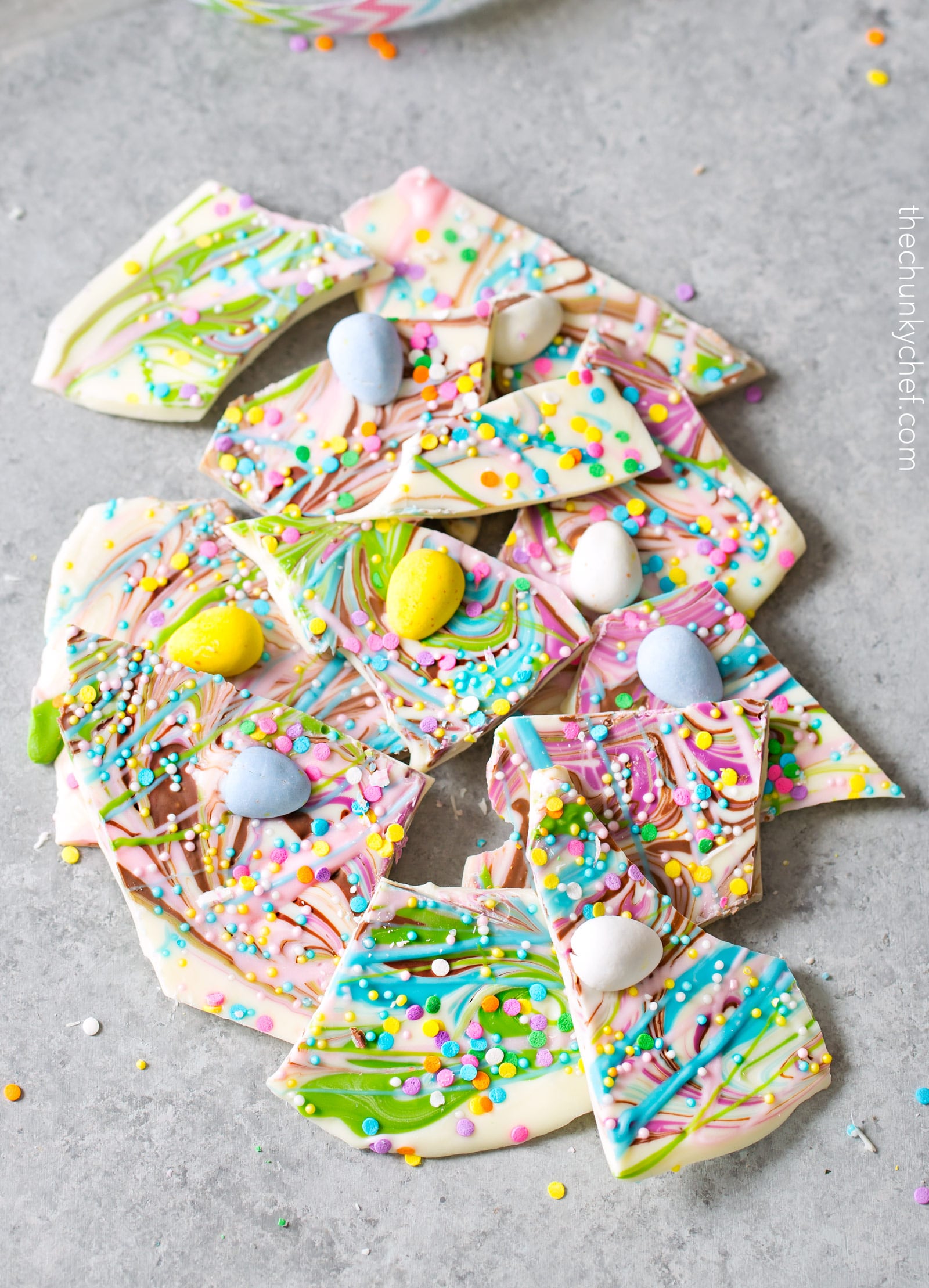 Brownie Batter White Chocolate Bark | A fun no bake bark dessert, made with white chocolate swirled together with milk chocolate brownie batter, and decorated in fun Spring colors! Easily customizable to any holiday and makes a great homemade gift! | http://thechunkychef.com