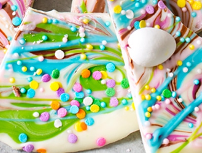 Brownie Batter White Chocolate Bark | A fun no bake bark dessert, made with white chocolate swirled together with milk chocolate brownie batter, and decorated in fun Spring colors! Easily customizable to any holiday and makes a great homemade gift! | http://thechunkychef.com