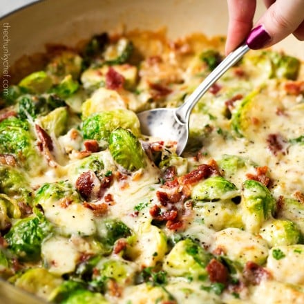 Cheesy Brussels Sprouts with Bacon | These Brussels sprouts are sautéed with shallots and garlic, topped with cream, two types of cheese, sprinkled with bacon, and baked until bubbly. It will convert even the most die hard Brussels sprouts haters! | http://thechunkychef.com