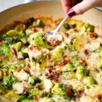 Crisp tender brussels sprouts baked in a rich and creamy cheese sauce, and topped with crispy bacon. This is the perfect holiday side dish recipe! #brusselssprouts #brussels #sidedish #easyrecipe #baked #gratin #cheesy #bacon #holiday #lowcarb #keto