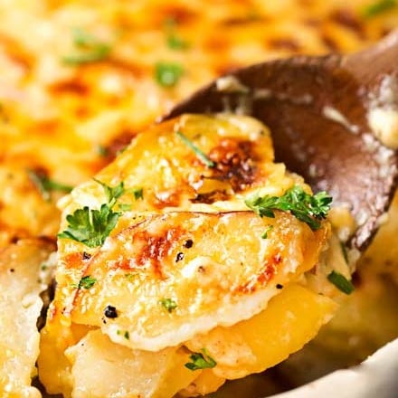 Velvety soft and tender layers of two kinds of potatoes, smothered in a rich 3 cheese garlic sauce, then topped with extra cheese for a perfectly crispy top! It's the scalloped potato dish you've been dreaming of your entire life! #scallopedpotatoes #potato #sidedish #holiday #Easter #cheese #potatoesaugratin #augratin #makeahead