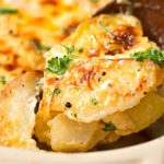 Garlic Parmesan Cheesy Scalloped Potatoes | Velvety soft and tender layers of two kinds of potatoes, smothered in a rich 3 cheese garlic sauce, then topped with extra cheese for a perfectly crispy top! It's the scalloped potato dish you've been dreaming of your entire life! | http://thechunkychef.com