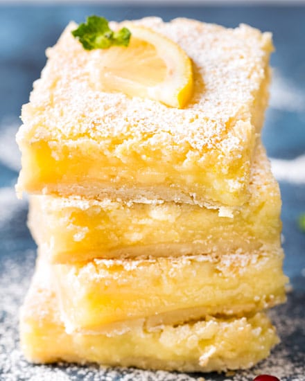 The best Creamy Lemon Bars have an easy shortbread crust and a layer of thick and creamy lemon filling. Perfectly tangy and sweet - such a classic dessert recipe that anyone can make! #lemonbars #lemonsquares #lemon #citrus #bars #dessert #baking #dessertrecipe #easyrecipe #spring