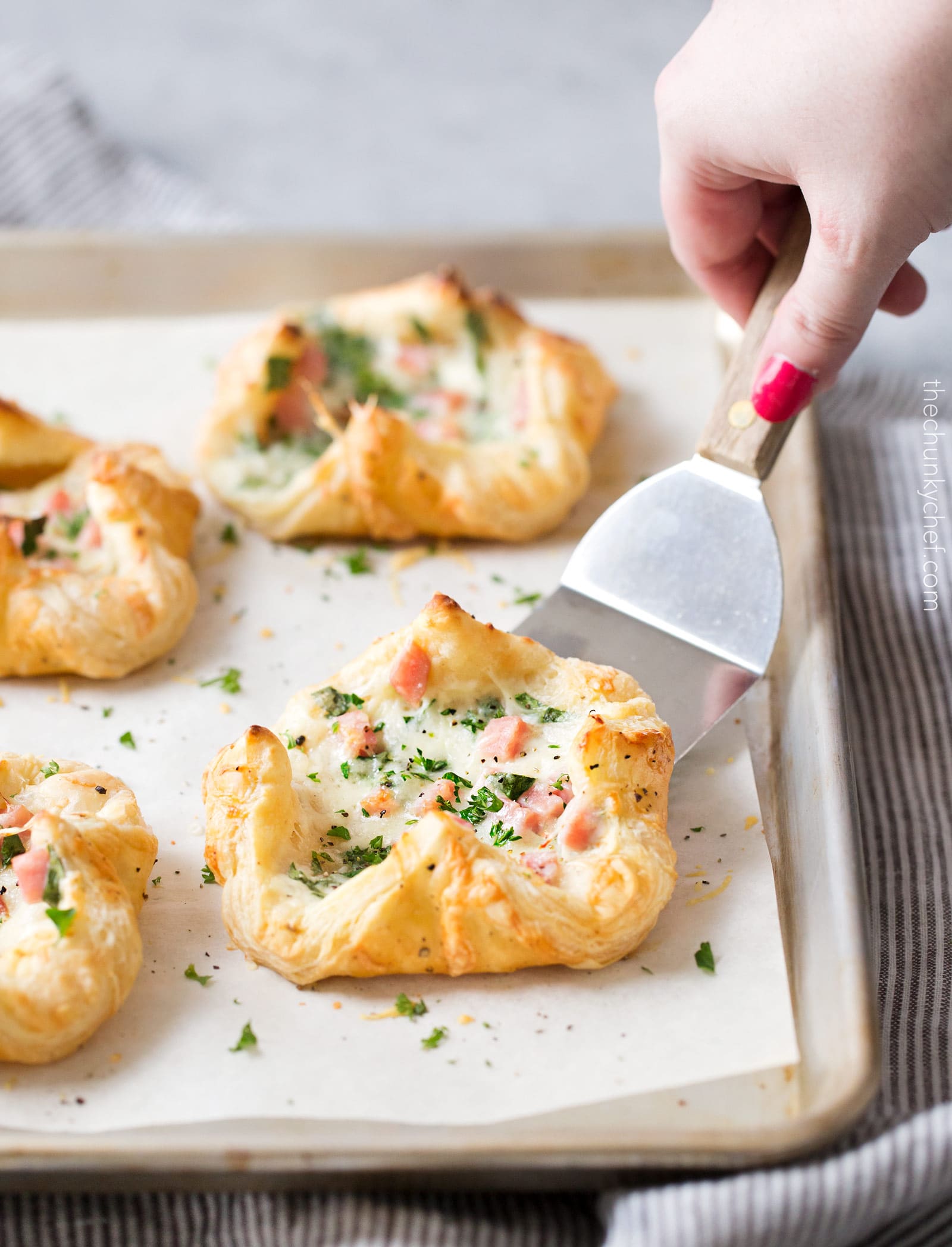 Ham and Cheese Spinach Puffs | Ready in just over 30 minutes, these spinach puffs are made with flaky puff pastry, wrapped around a creamy mixture of ham, gruyere cheese and fresh spinach. Perfect for using leftover ham! | http://thechunkychef.com