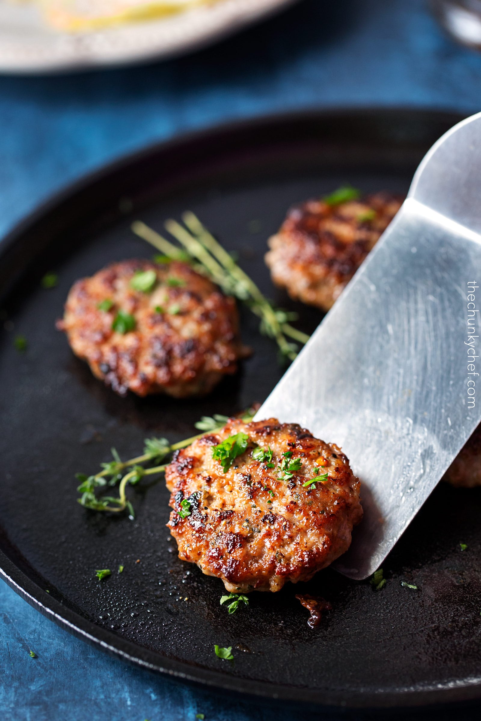 Homemade Maple Breakfast Sausage | These breakfast sausage patties are made with a combo of ground turkey and pork, savory herbs, and sweet maple syrup. The mouthwatering combo gives way to a low calorie homemade version of your favorite breakfast food! | http://thechunkychef.com