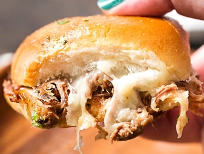 Baked Italian Beef Sliders | Slider buns are piled high with shredded Italian beef and gooey provolone cheese, brushed with melted garlic butter and baked until gooey and mouthwatering! | http://thechunkychef.com