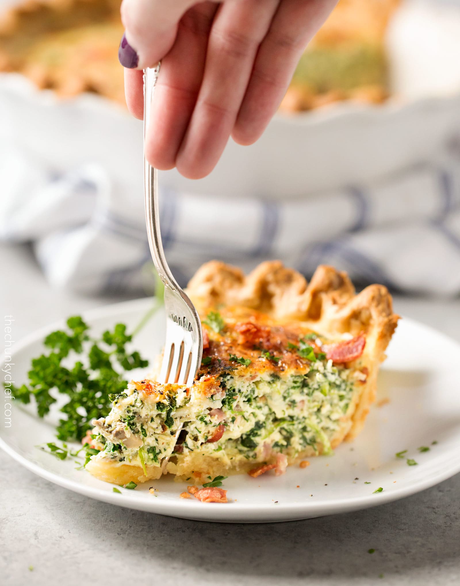 Basic Cheesy Spinach Quiche with Bacon | This easy quiche is loaded with spinach, ham, bacon, caramelized onions, mushrooms and Gruyere! No complicated dinner here, it uses frozen pie crust! | http://thechunkychef.com