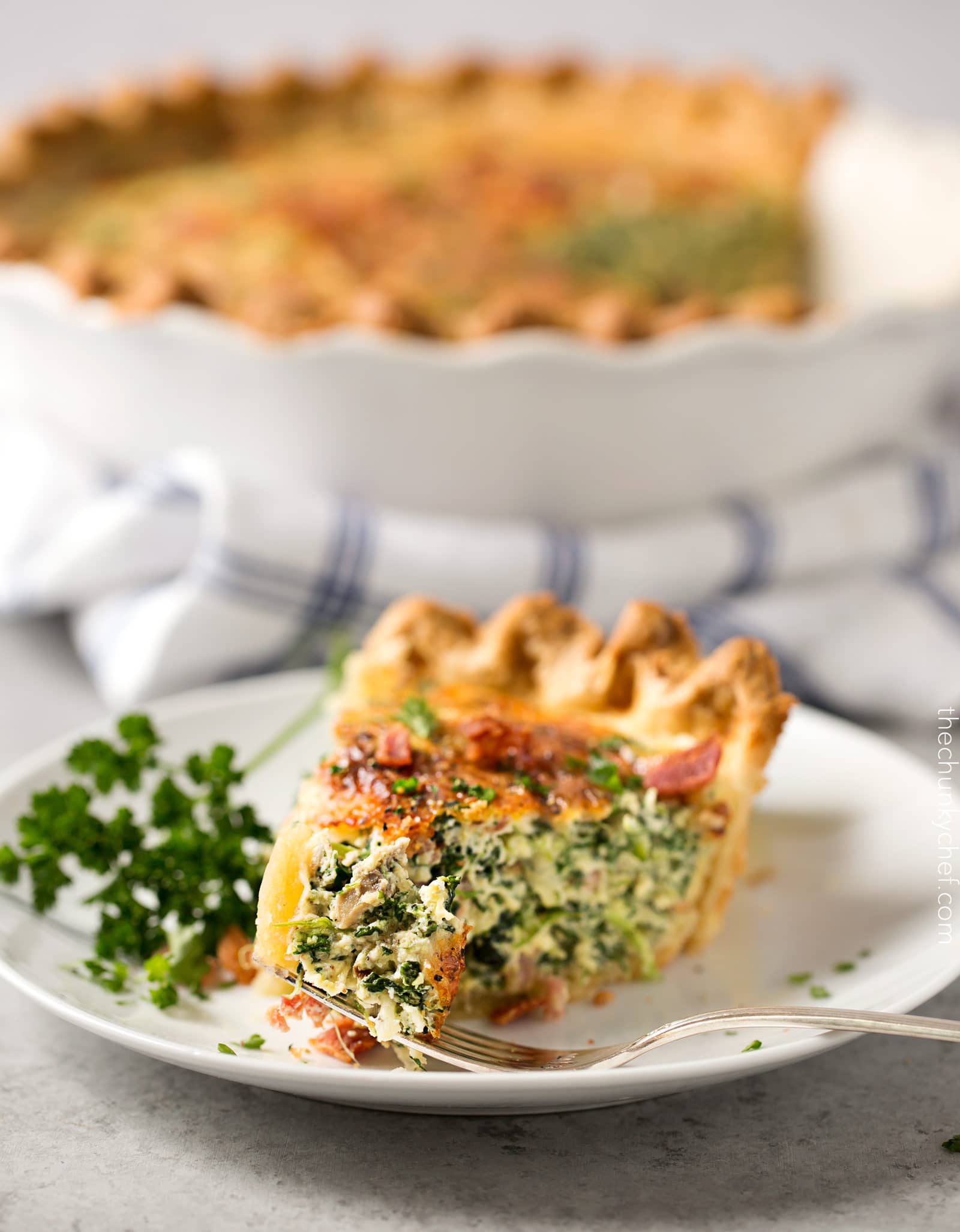 Basic Cheesy Spinach Quiche with Bacon | This easy quiche is loaded with spinach, ham, bacon, caramelized onions, mushrooms and Gruyere! No complicated dinner here, it uses frozen pie crust! | http://thechunkychef.com