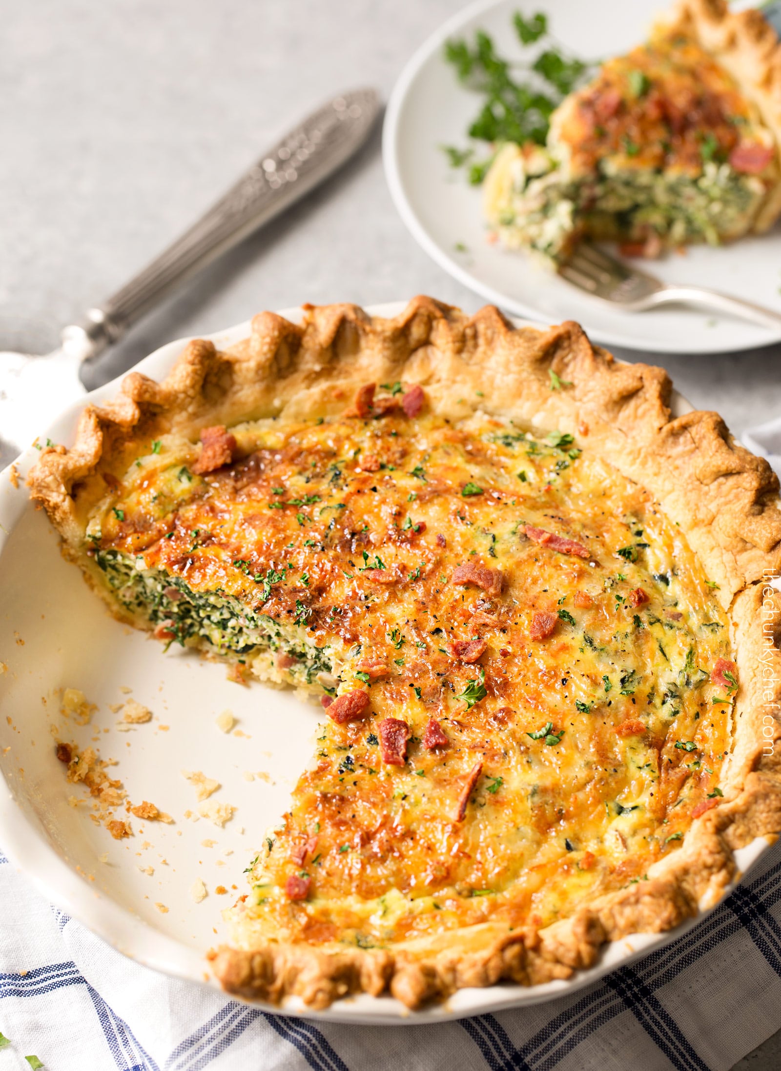 Basic Cheesy Spinach Quiche with Bacon | This easy quiche is loaded with spinach, ham, bacon, caramelized onions, mushrooms and Gruyere! No complicated dinner here, it uses frozen pie crust! | http://thechunkychef.com