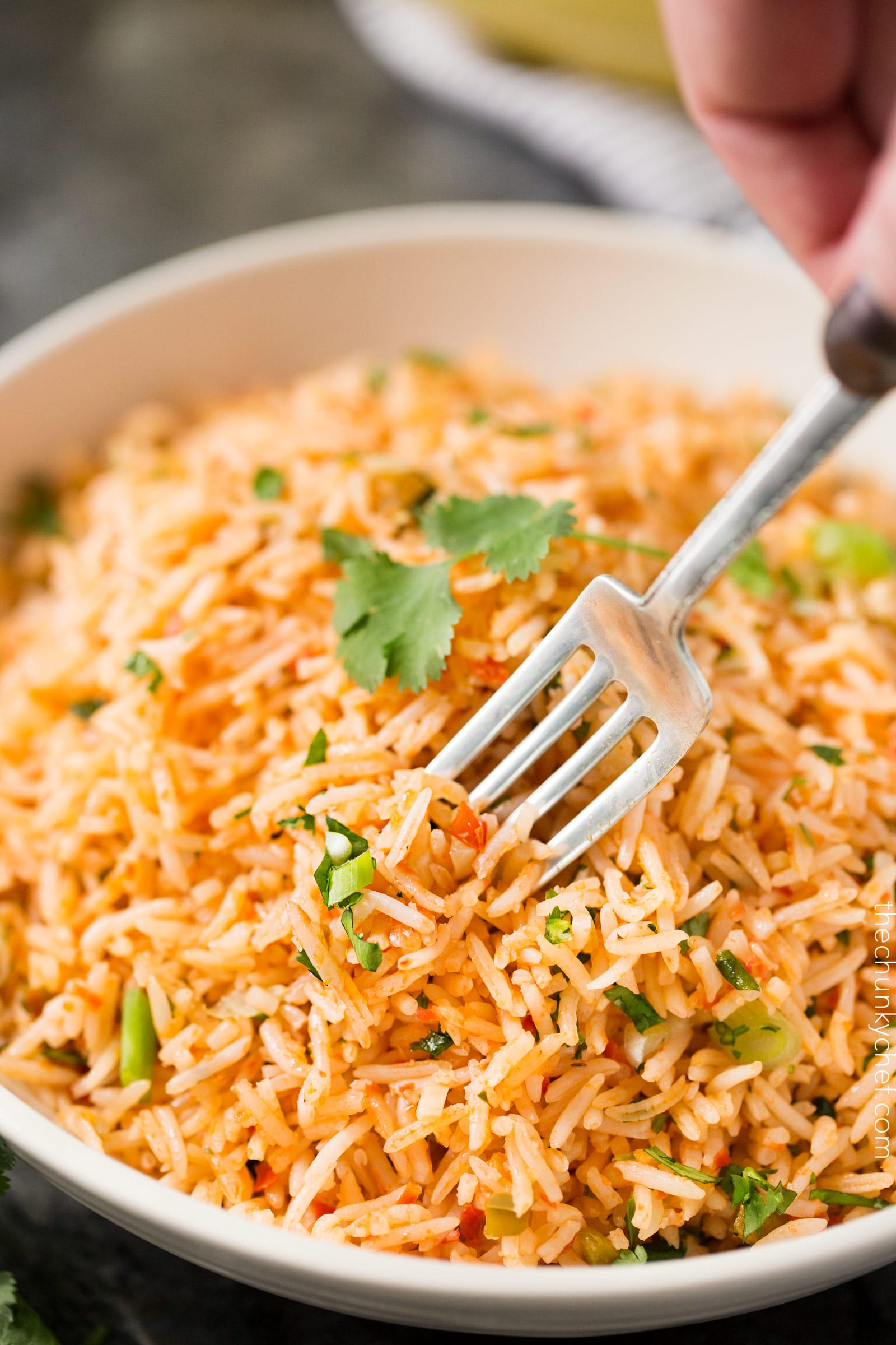 Easy Baked Mexican Rice | This foolproof method for cooking rice tastes just like the rice from your favorite Mexican restaurant... full of flavor and cooked to perfectly fluffy perfection! | http://thechunkychef.com