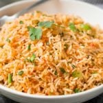 Easy Baked Mexican Rice | This foolproof method for cooking rice tastes just like the rice from your favorite Mexican restaurant... full of flavor and cooked to perfectly fluffy perfection! | http://thechunkychef.com