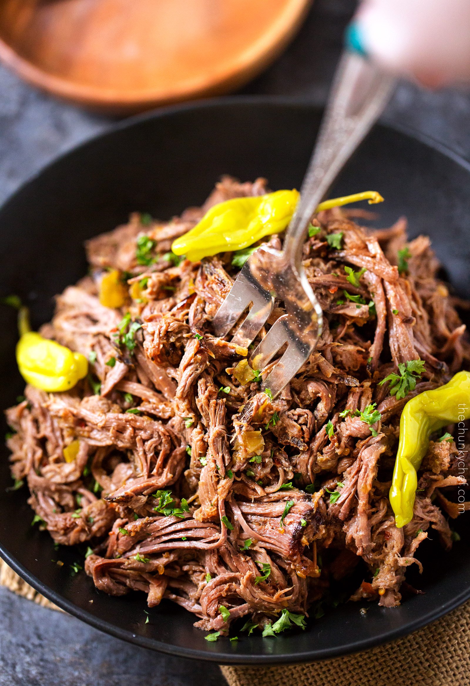 Slow Cooker Shredded Italian Beef | Tangy and spicy, this Italian beef is easily cooked in a slow cooker until fork tender, then shredded, for the ultimate in delicious easy weeknight dinners! | http://thechunkychef.com