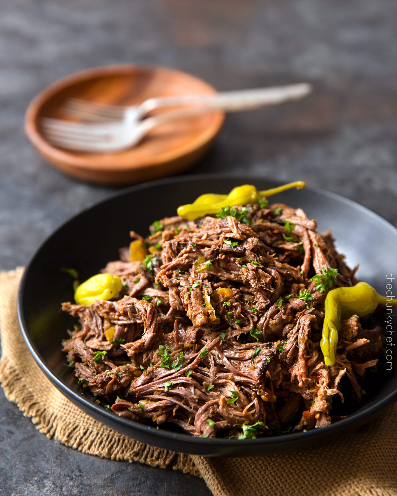 Slow Cooker Shredded Italian Beef | Tangy and spicy, this Italian beef is easily cooked in a slow cooker until fork tender, then shredded, for the ultimate in delicious easy weeknight dinners! | http://thechunkychef.com