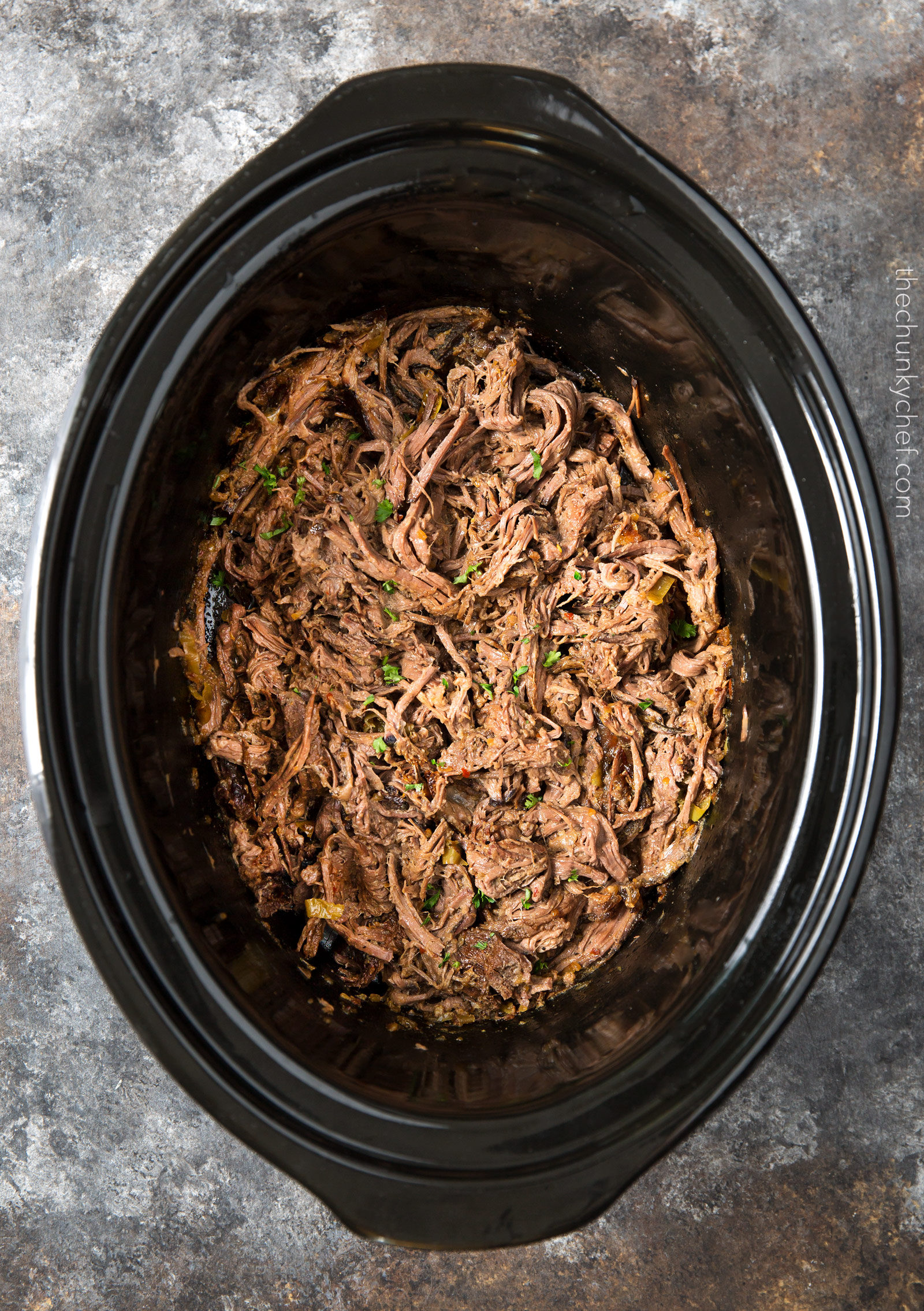 Slow Cooker Shredded Italian Beef | Tangy and spicy, this Italian beef is easily cooked in a slow cooker until fork tender, then shredded, for the ultimate in delicious easy weeknight dinners! | http://thechunkychef.com