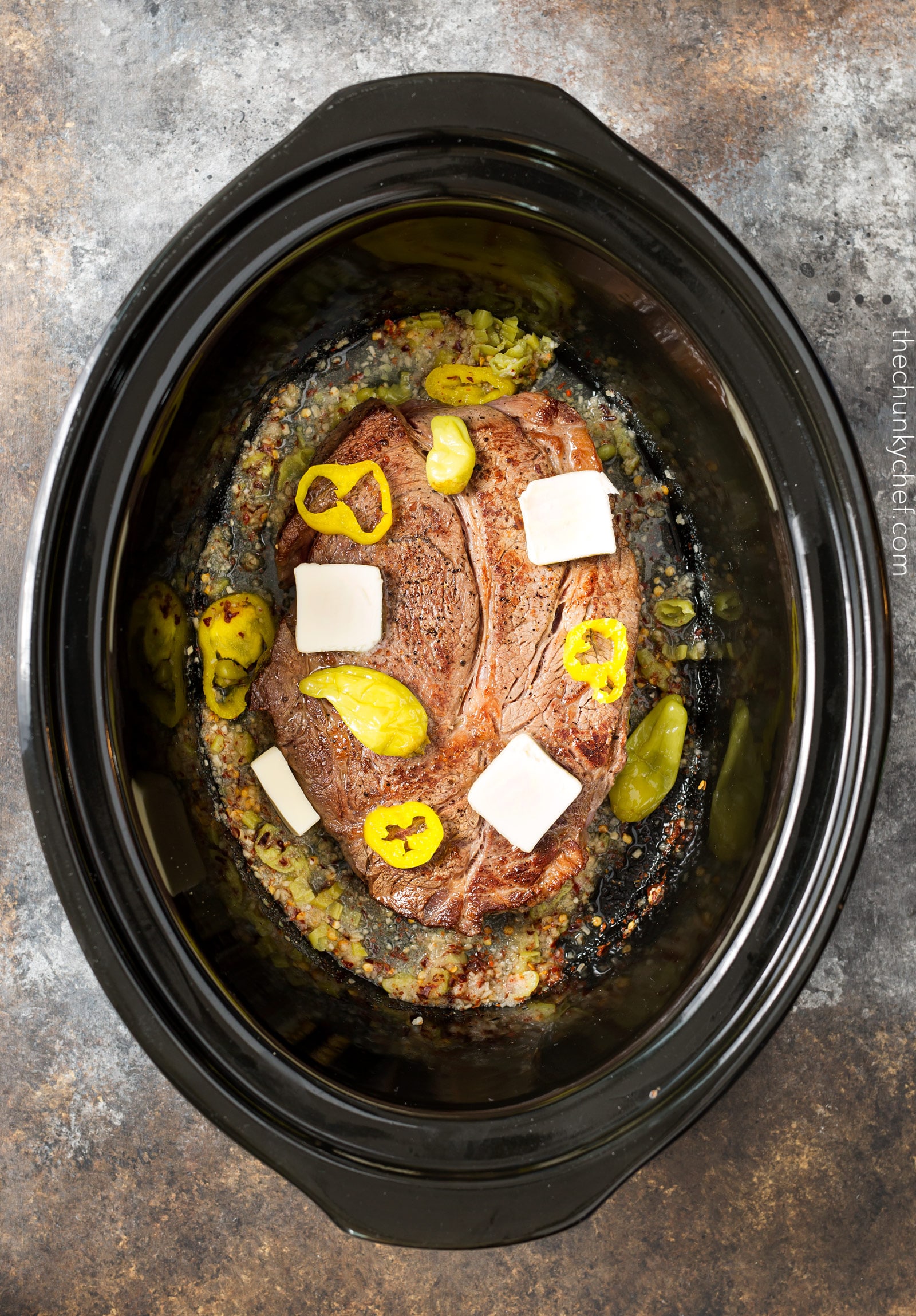 Slow Cooker Shredded Italian Beef | Tangy and spicy, this Italian beef is easily cooked in a slow cooker until fork tender, then shredded, for the ultimate in delicious easy weeknight dinners! | http://thechunkychef.com