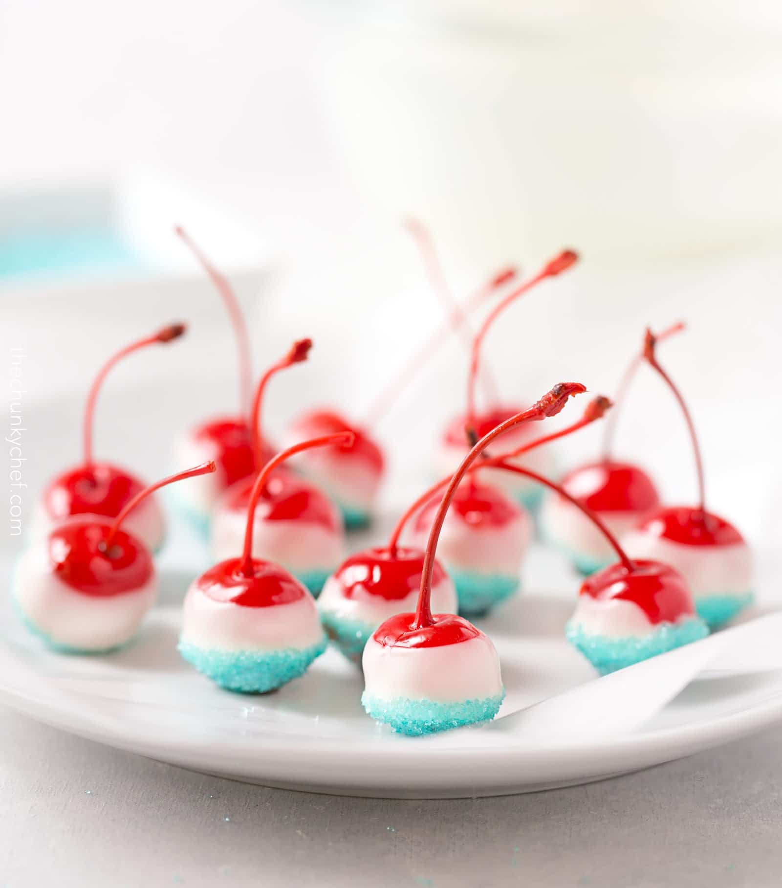 Cola Soaked Firecracker Cherries | Maraschino cherries are soaked in sweet cola, dipped in white chocolate and kissed with blue sugar for a kid-friendly patriotic dessert! | http://thechunkychef.com
