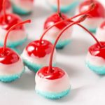 Cola Soaked Firecracker Cherries | Maraschino cherries are soaked in sweet cola, dipped in white chocolate and kissed with blue sugar for a kid-friendly patriotic dessert! | http://thechunkychef.com