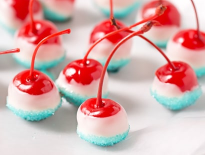 Cola Soaked Firecracker Cherries | Maraschino cherries are soaked in sweet cola, dipped in white chocolate and kissed with blue sugar for a kid-friendly patriotic dessert! | http://thechunkychef.com