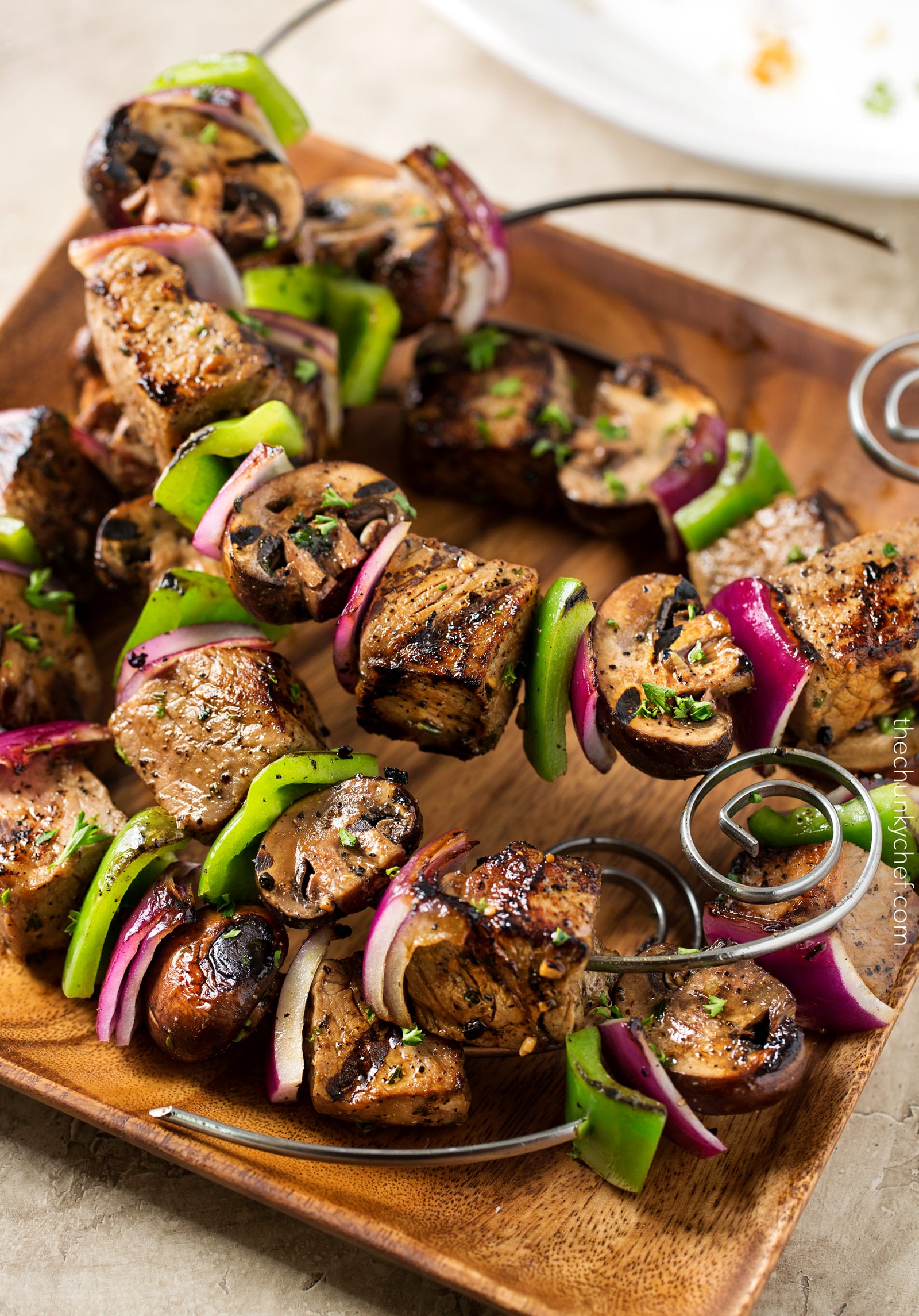 Easy Grilled Steakhouse Kebabs | Bite-sized steak pieces and mushrooms are marinated in an incredibly easy marinade, then skewered with onions and peppers, and grilled to juicy steakhouse perfection! You need these at your next BBQ! | http://thechunkychef.com