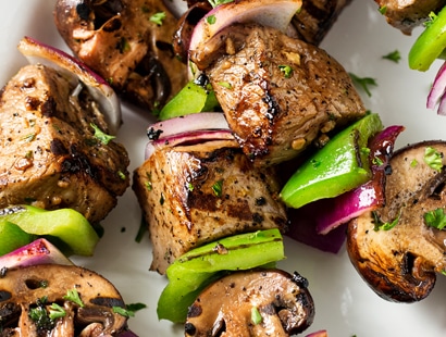 Easy Grilled Steakhouse Kebabs | Bite-sized steak pieces and mushrooms are marinated in an incredibly easy marinade, then skewered with onions and peppers, and grilled to juicy steakhouse perfection! You need these at your next BBQ! | http://thechunkychef.com