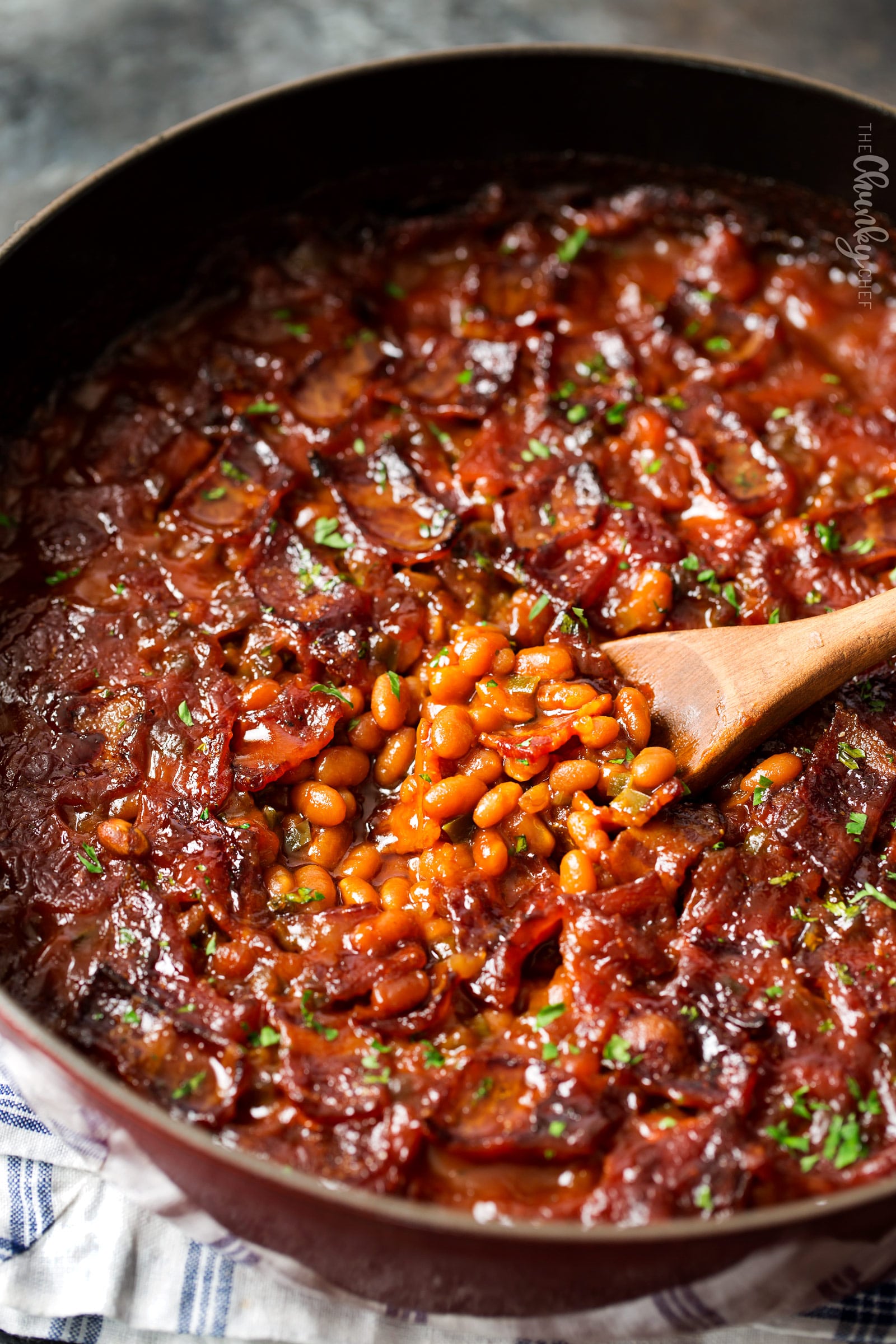 Spicy Baked Beans with Bacon | Perfect for cookouts or summer BBQ's, these baked beans with bacon have a mouthwatering spicy kick from jalapeños that make for an unforgettable side dish! | http://thechunkychef.com