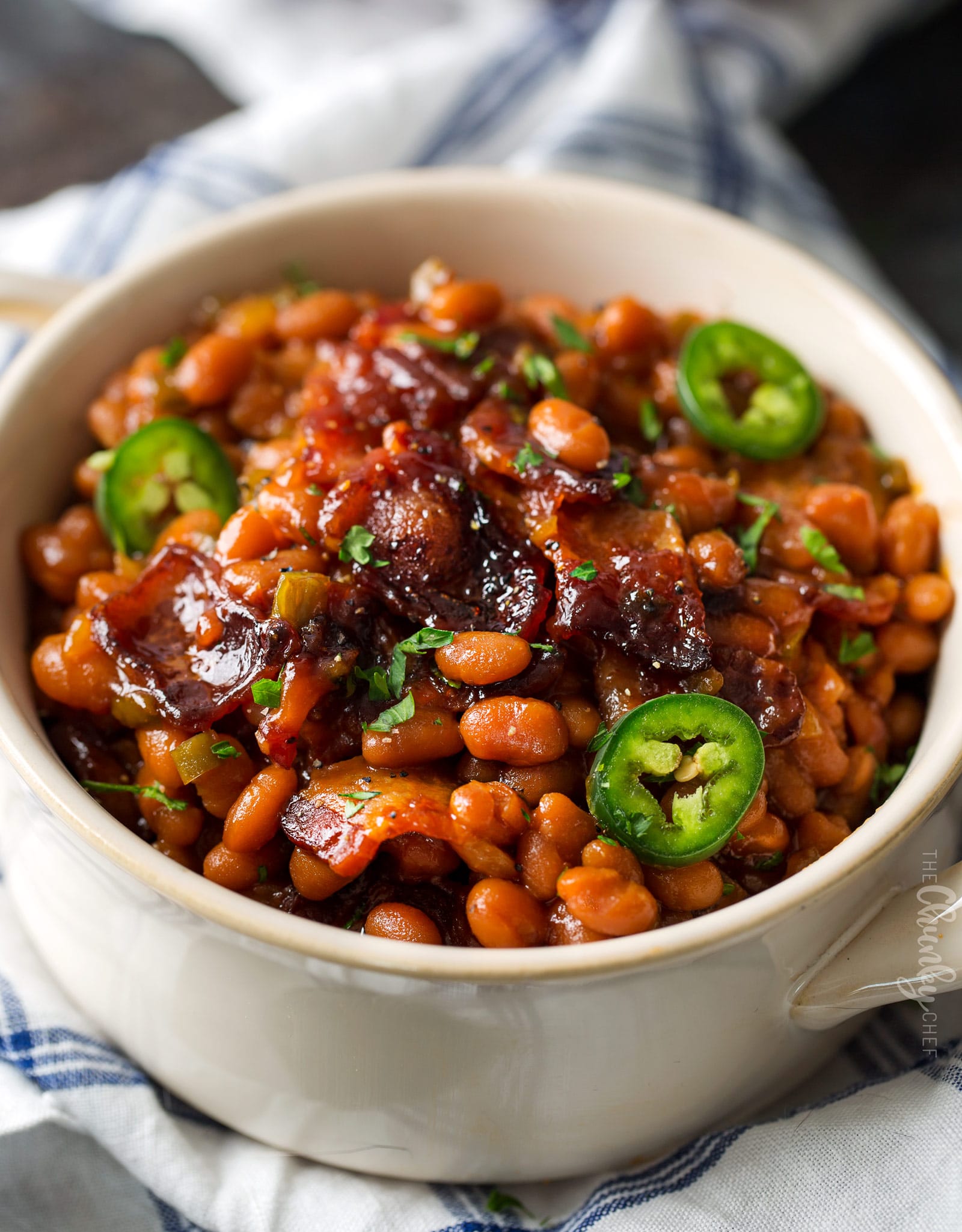 Spicy Baked Beans with Bacon | Perfect for cookouts or summer BBQ's, these baked beans with bacon have a mouthwatering spicy kick from jalapeños that make for an unforgettable side dish! | http://thechunkychef.com