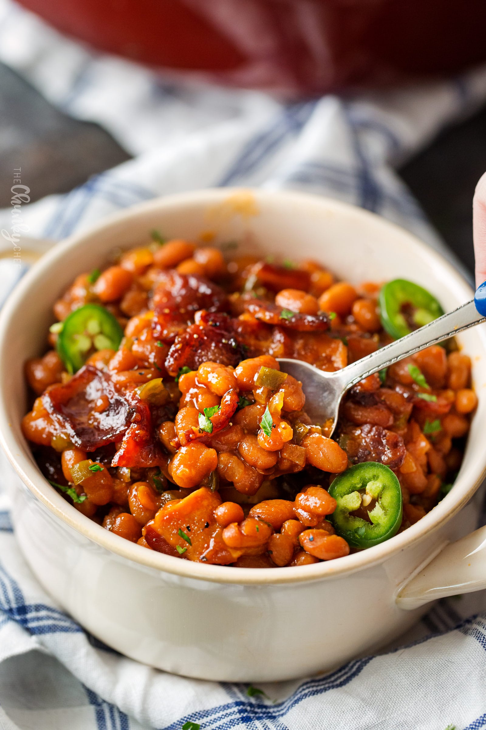 Spicy Baked Beans with Bacon | Perfect for cookouts or summer BBQ's, these baked beans with bacon have a mouthwatering spicy kick from jalapeños that make for an unforgettable side dish! | http://thechunkychef.com