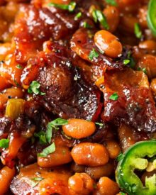 Spicy Baked Beans with Bacon | Perfect for cookouts or summer BBQ's, these baked beans with bacon have a mouthwatering spicy kick from jalapeños that make for an unforgettable side dish! | http://thechunkychef.com