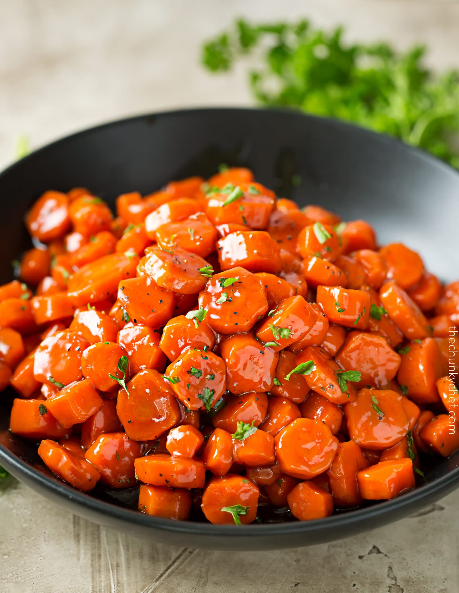 Spicy Bourbon Glazed Carrots | You'll love these easy glazed carrots made with bourbon, brown sugar and cayenne! They're perfect for a weeknight dinner or holiday feast! | http://thechunkychef.com