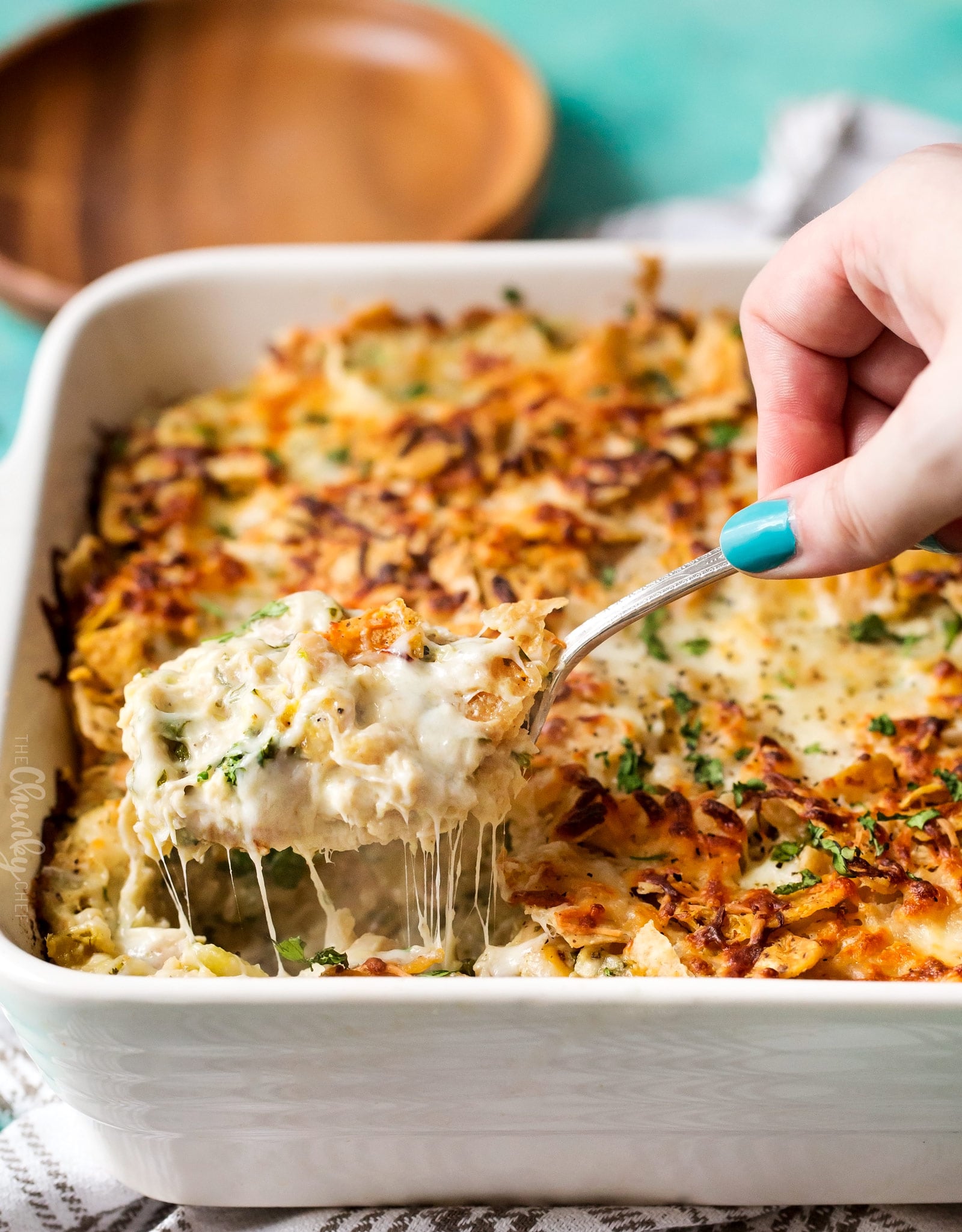 Cheesy Chicken Tortilla Casserole | A rotisserie chicken, creamy salsa verde sauce, plenty of gooey cheese and crunchy tortilla chips... it's the perfect casserole that's easy to prep ahead for a weeknight dinner! | http://thechunkychef.com