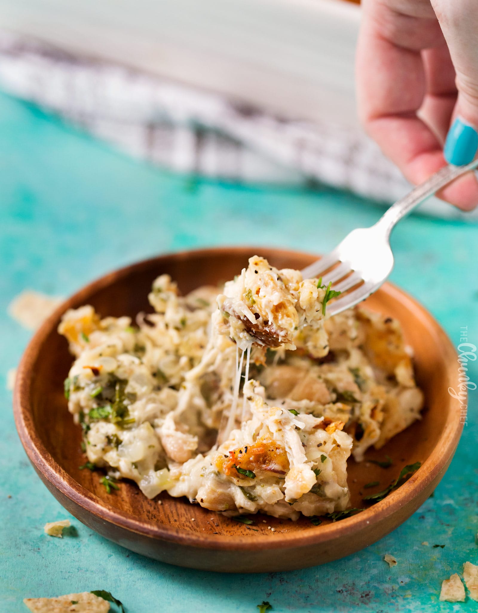 Cheesy Chicken Tortilla Casserole | A rotisserie chicken, creamy salsa verde sauce, plenty of gooey cheese and crunchy tortilla chips... it's the perfect casserole that's easy to prep ahead for a weeknight dinner! | http://thechunkychef.com